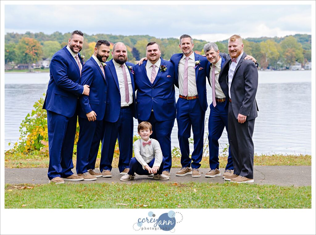 Casual portrait of groom and groomsman with ring bearer in front of Turkeyfoot Lake in Akron Ohio on a September day