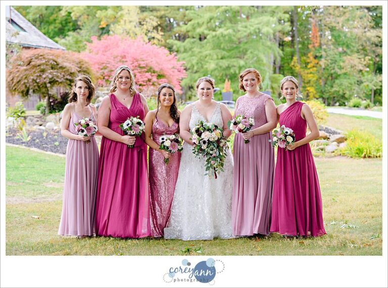 Bride with bridesmaids in varied pink gowns at Tudor House on Portage Lakes in Akron Ohio
