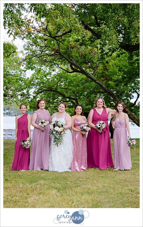 Bride with bridesmaids in varied pink gowns at Tudor House on Portage Lakes in Akron Ohio
