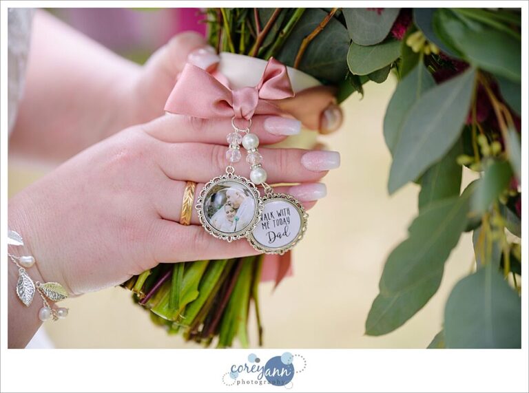 Bride showing charms with her deceased father on her bridal bouquet