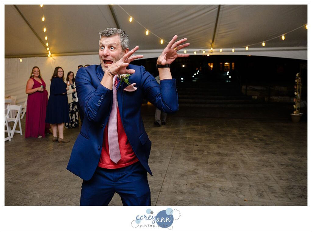 Fun dance floor shenanigans with groom and his family during wedding reception at Tudor House on Portage Lakes in Akron Ohio