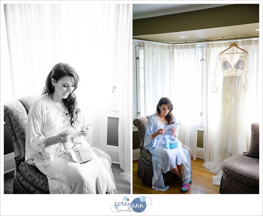Bride sitting by her dress which is hanging in a window reading a letter before her wedding in Cleveland Ohio