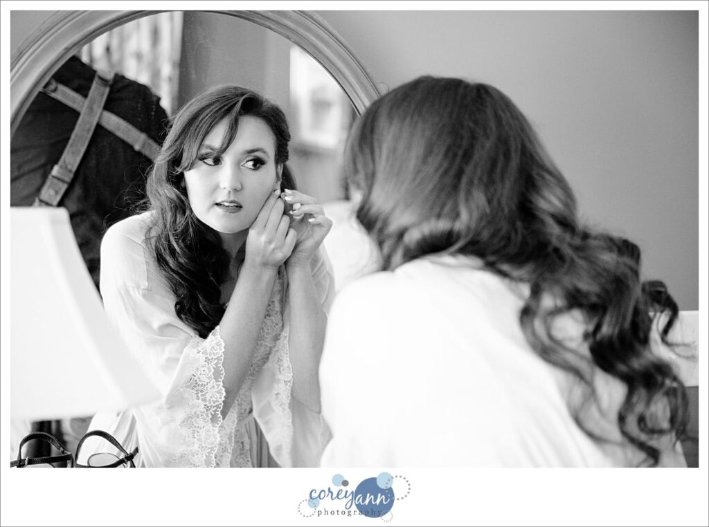 Bride putting in earrings before wedding in Cleveland Ohio