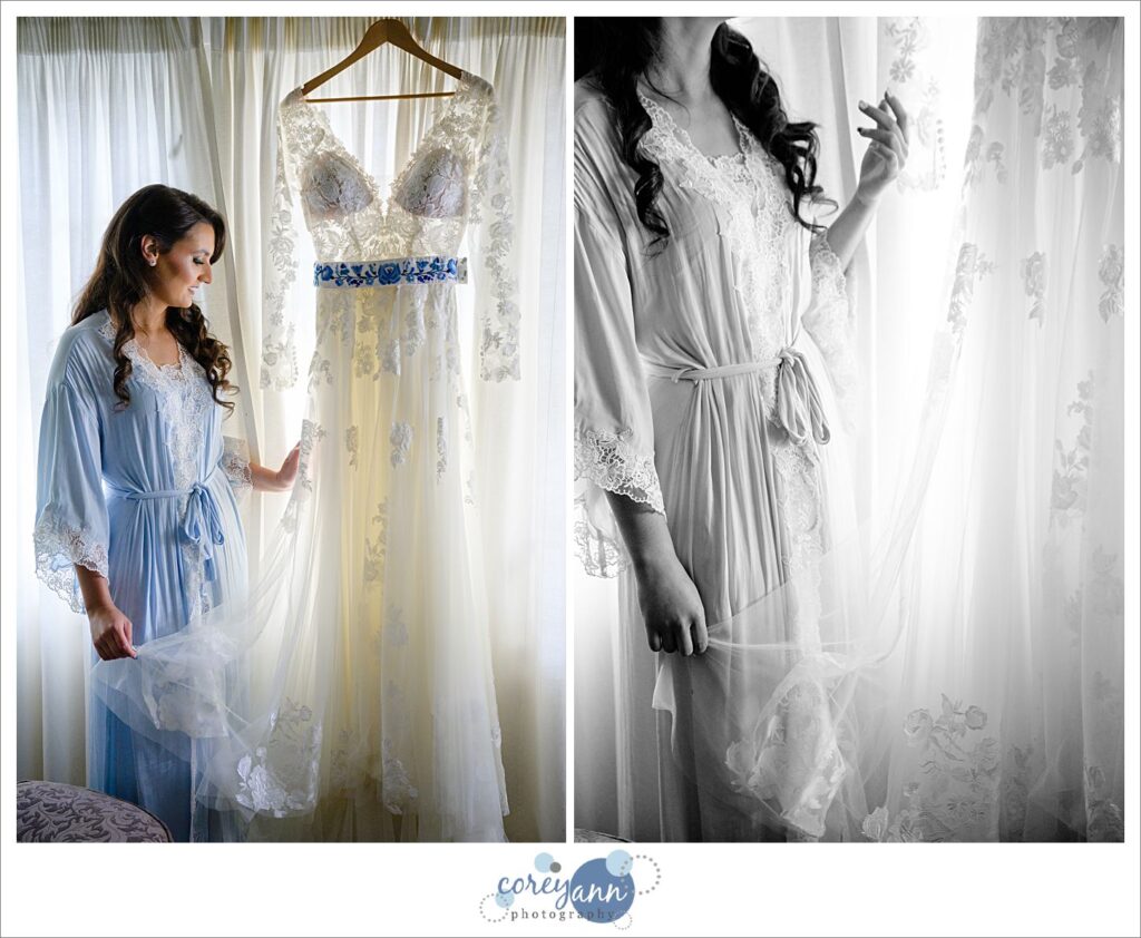 Bride touching her dress and admiring it as its hanging