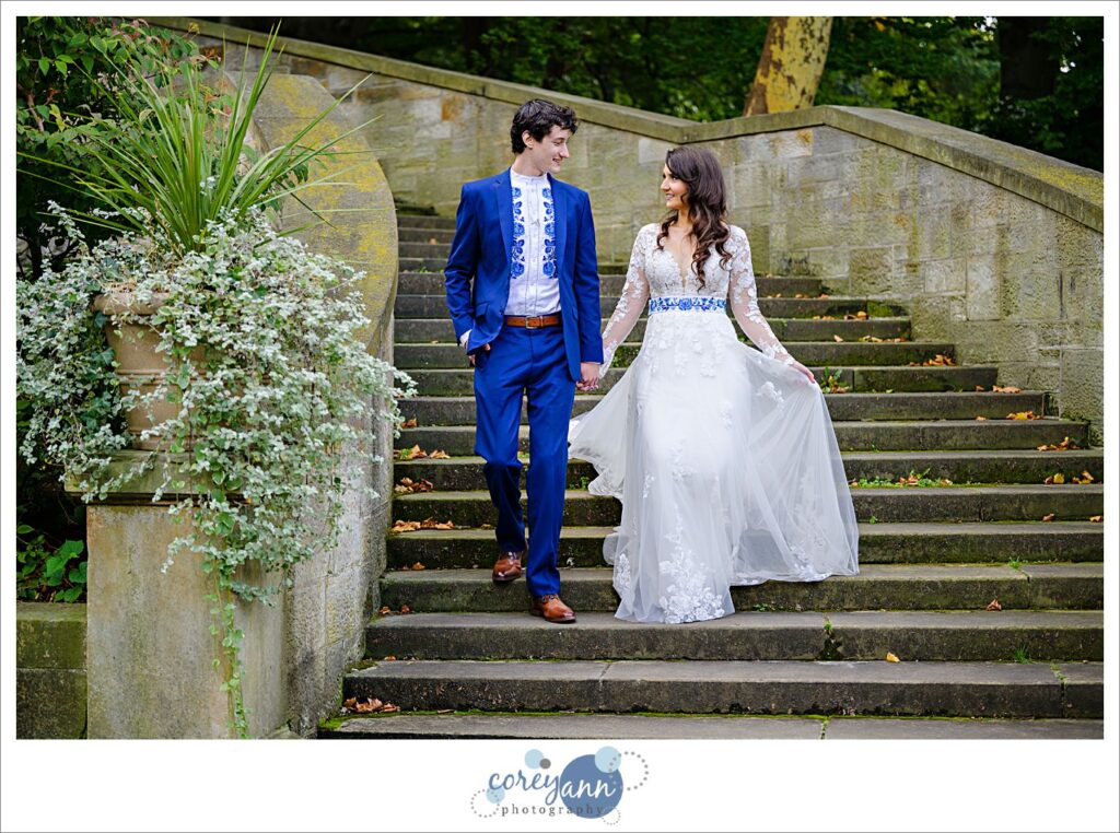 Bride and Groom walking down stairs at the Italian Cultural Gardens in Cleveland before their wedding in October