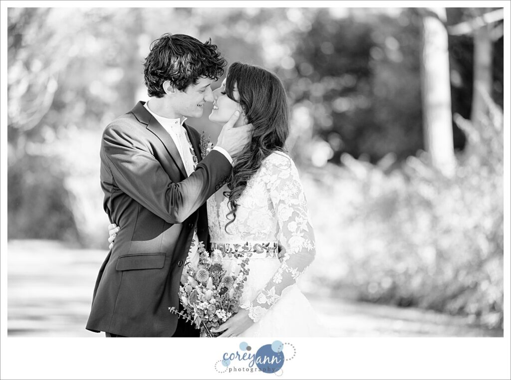 Black and white wedding portrait of a bride and groom teeth kissing in Cleveland Ohio