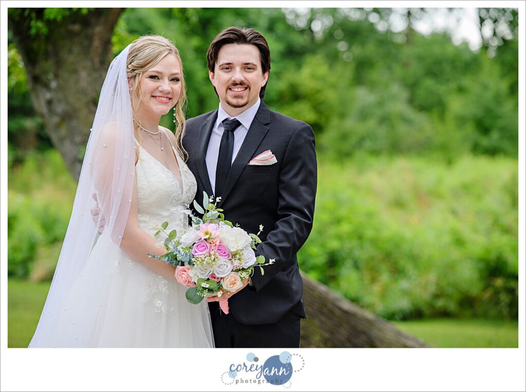 Bride and groom standing outside after a rainstorm during their wedding at The Barn of Canal Fulton 