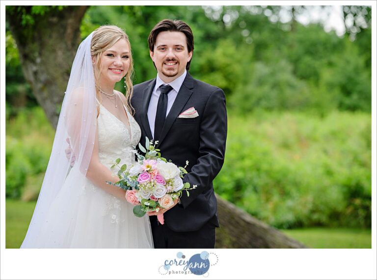 Bride and groom standing outside after a rainstorm during their wedding at The Barn of Canal Fulton