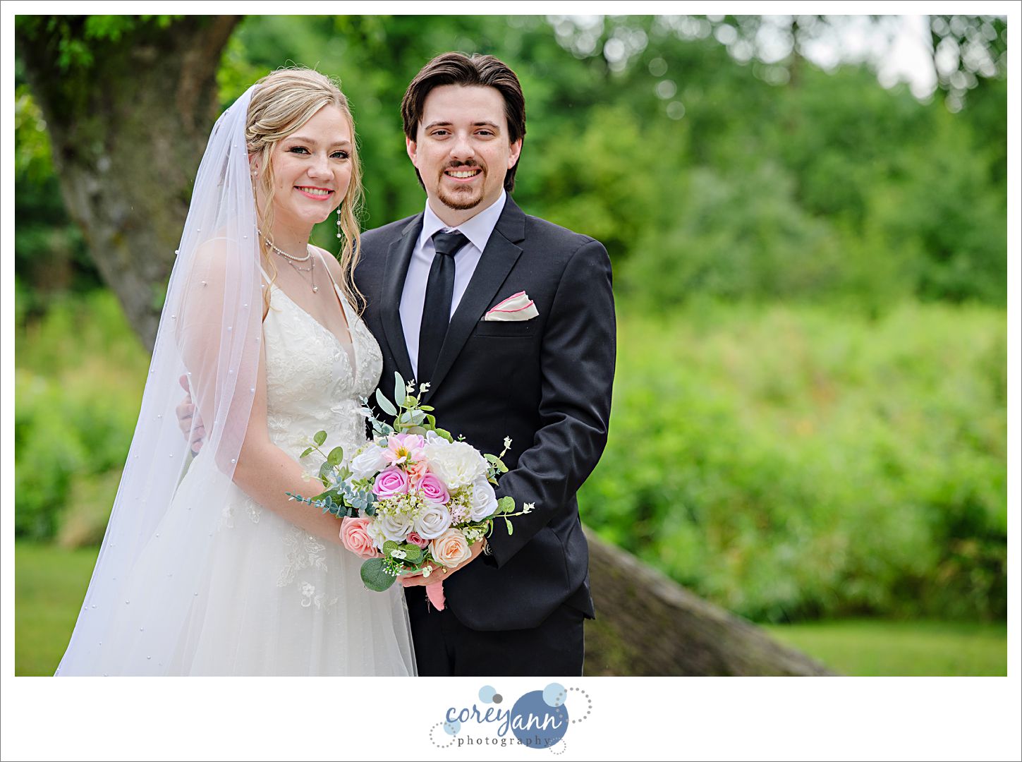 Bride and groom standing outside after a rainstorm during their wedding at The Barn of Canal Fulton