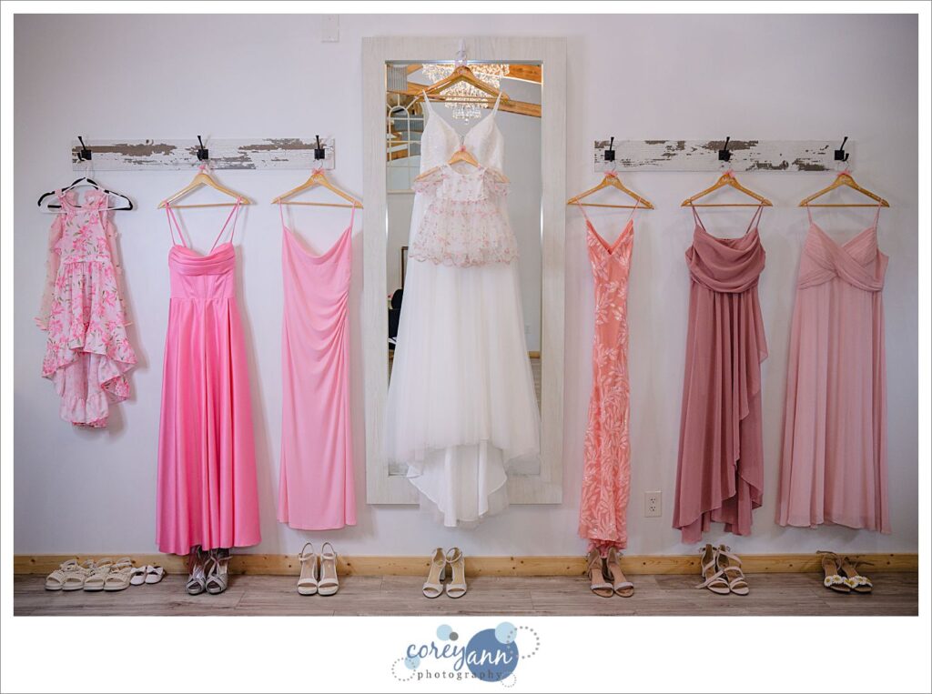 Wedding dress and bridesmaid dresses hanging up at The Barn of Canal Fulton