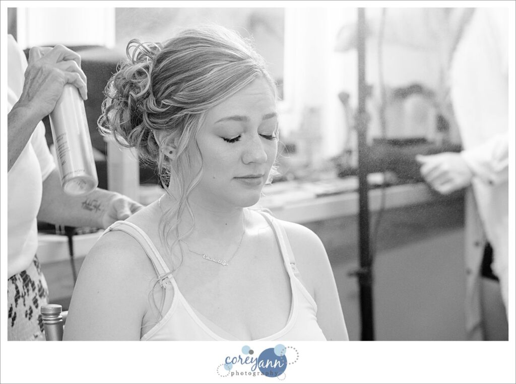 Bride getting hair done before wedding at The Barn of Canal Fulton
