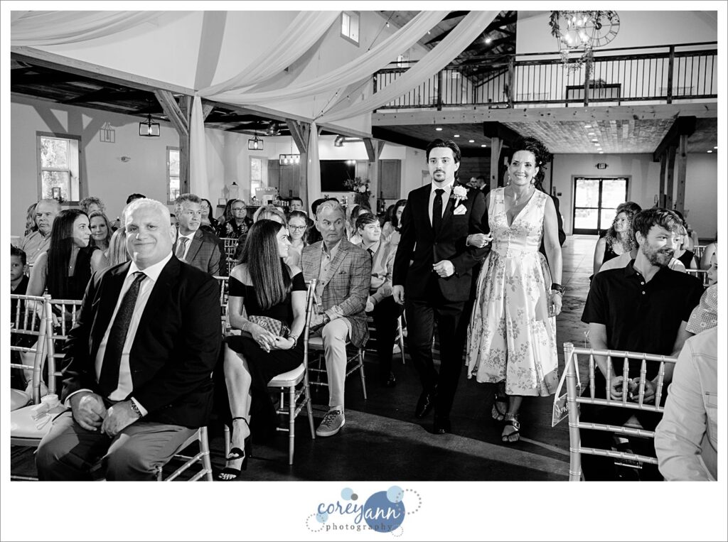Black and white photo of the groom and his Mom walking down the aisle for wedding ceremony in Ohio