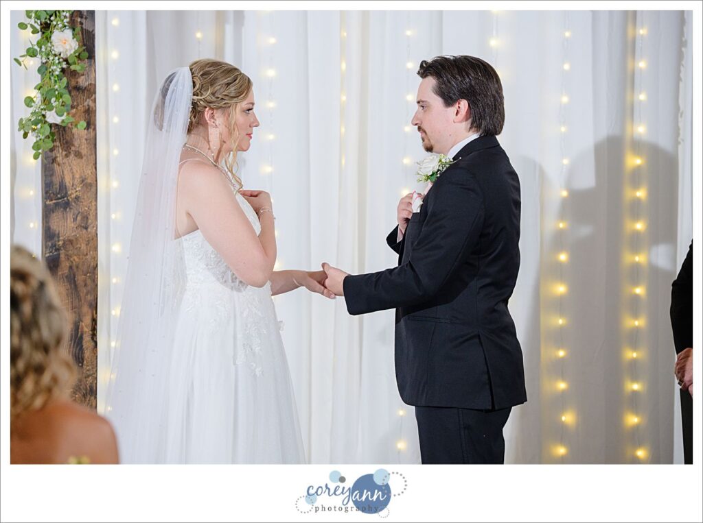 Bride and Groom holding wedding rings against chest before exchanging them in Canal Fulton wedding