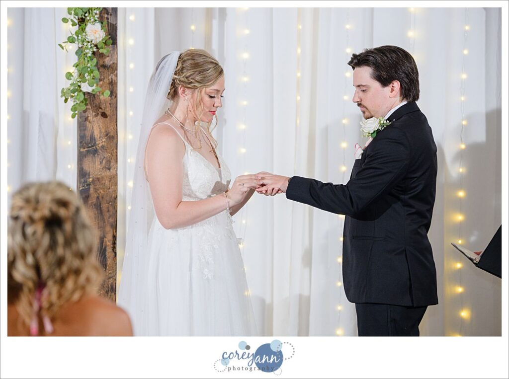 Ring exchange during wedding ceremony at The Barn of Canal Fulton