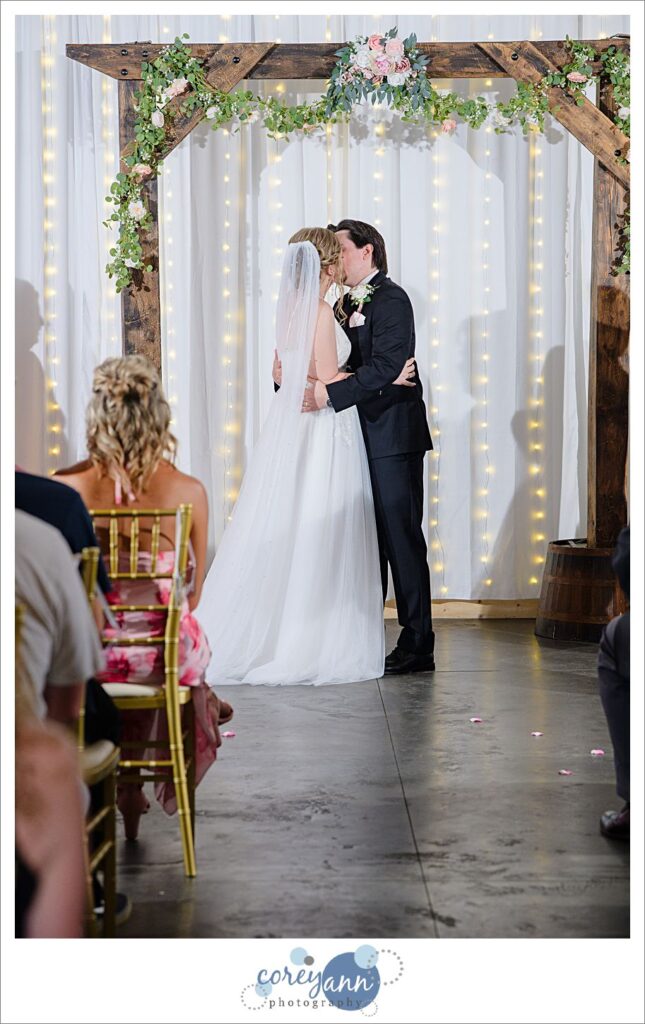 Bride and Groom kissing after wedding ceremony at The Barn of Canal Fulton