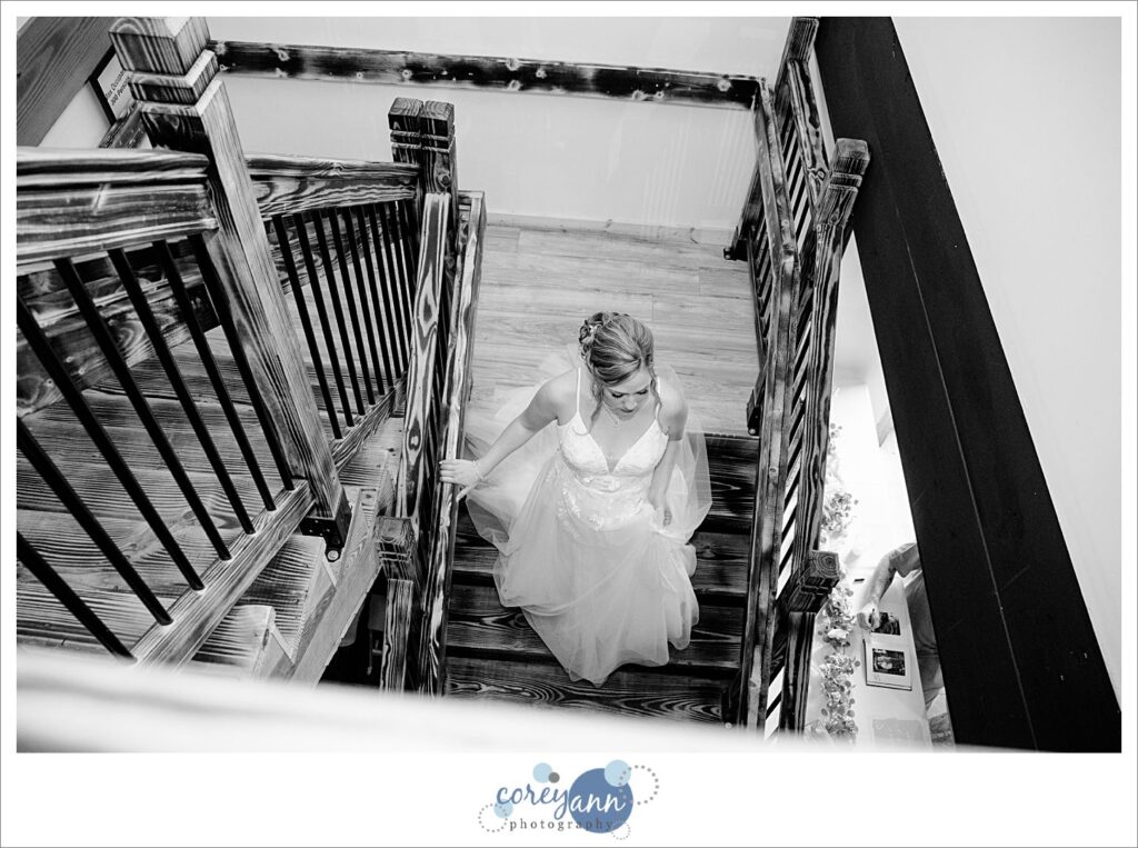 Bride walking down stairs at The Barn of Canal Fulton