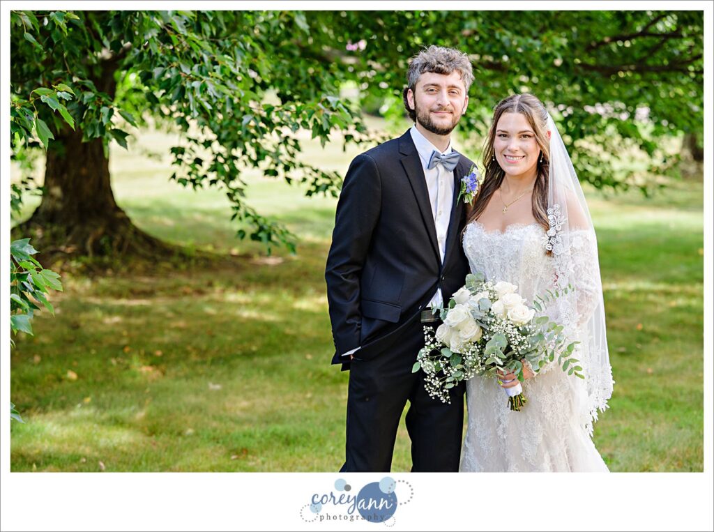 Bride and groom posing for a wedding portrait outside of St. Haralambos Greek Orthodox Church in Canton Ohio