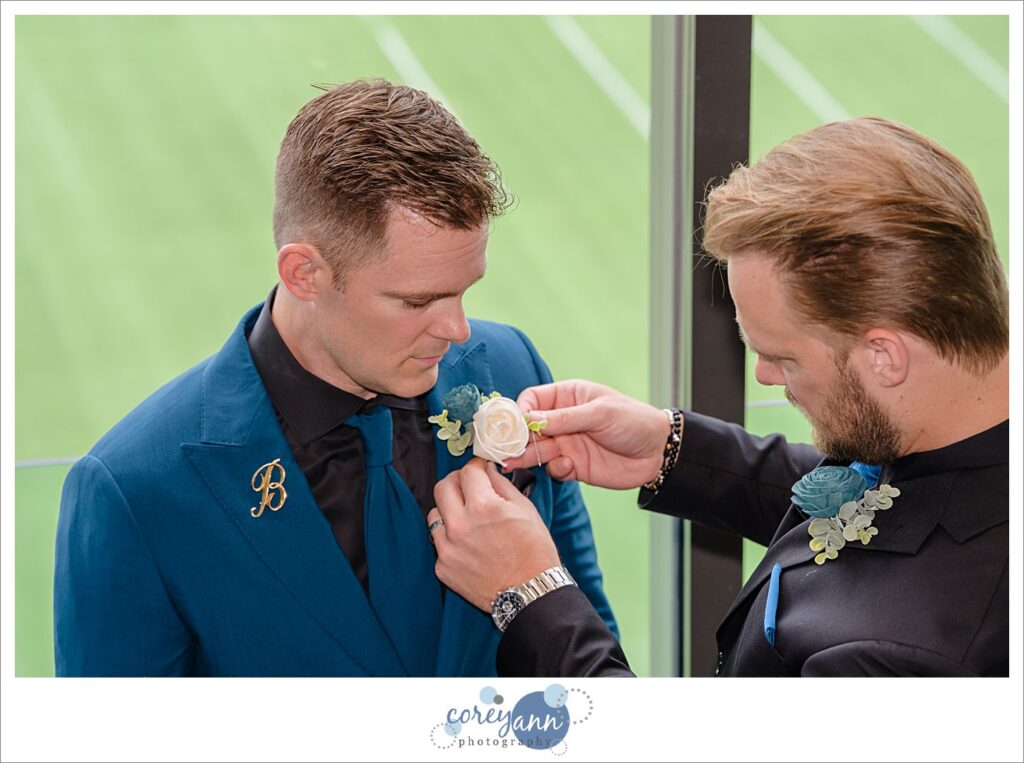 groom getting ready for wedding at pro football hall of fame in Canton ohio