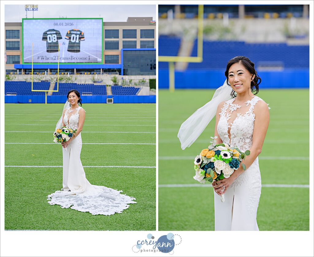 bride posing after wedding on football field at tom benson hall of fame stadium in canton ohio