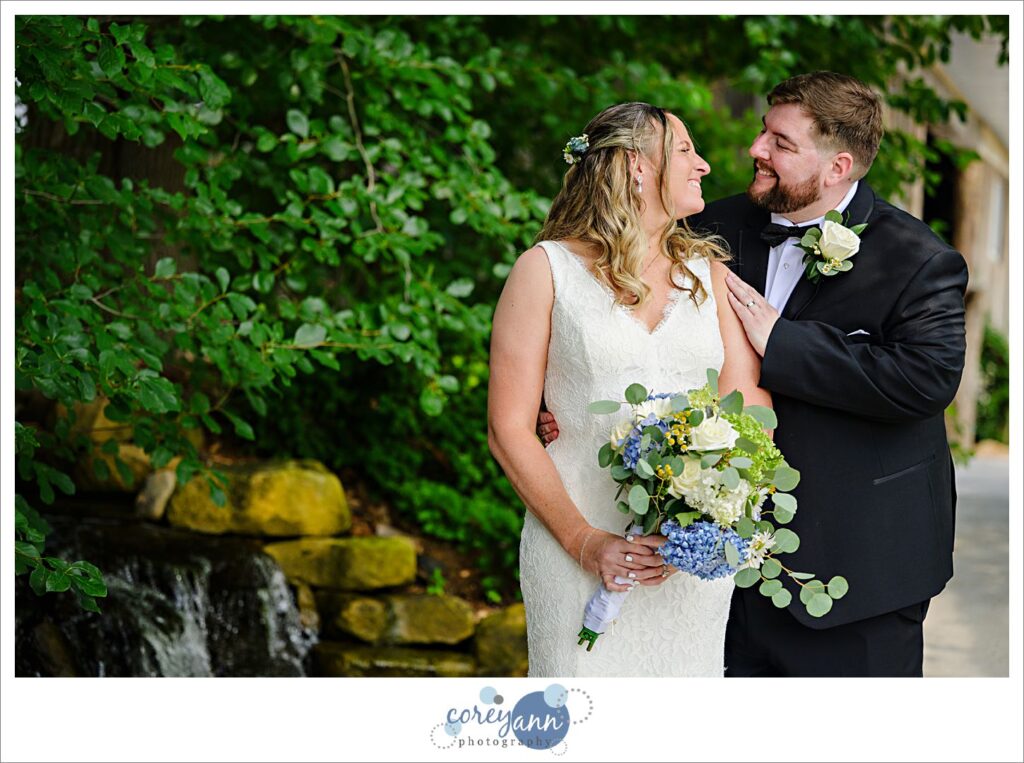Bride and Groom smiling at each other after wedding at Haymaker's Mill 1875 in North Canton Ohio