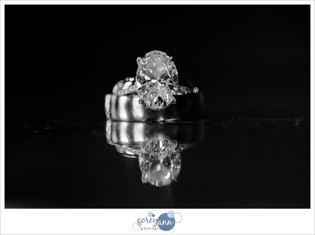 Wedding rings reflecting on dark surface