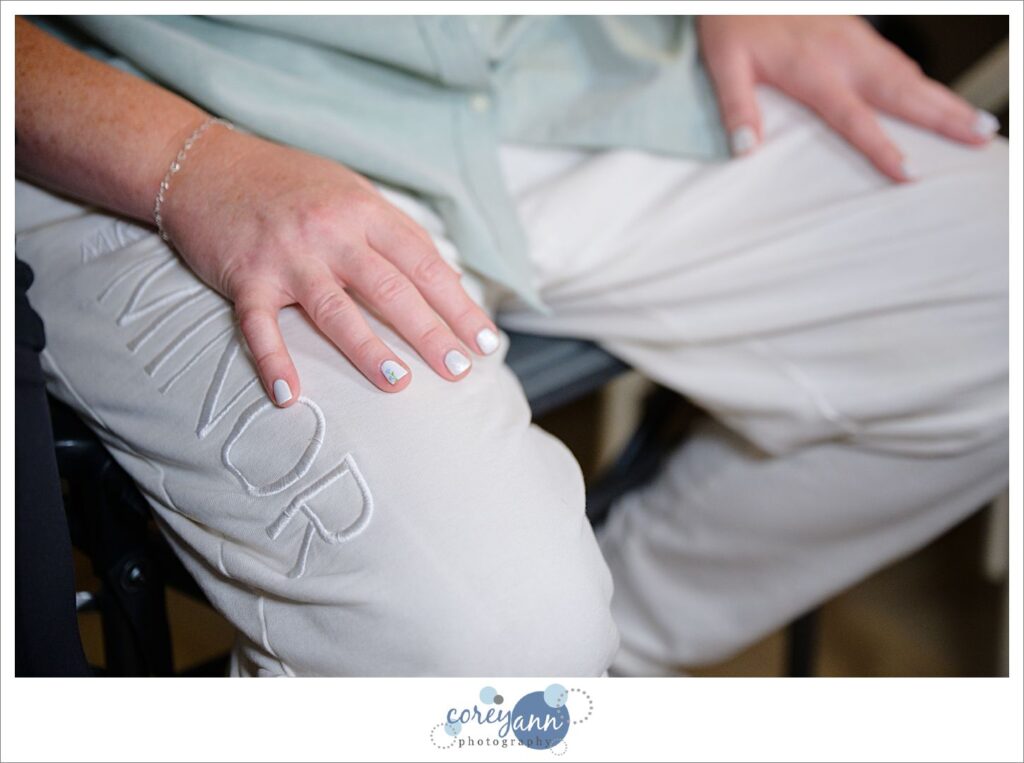 Bride's hands with custom nail polish with blue flowers