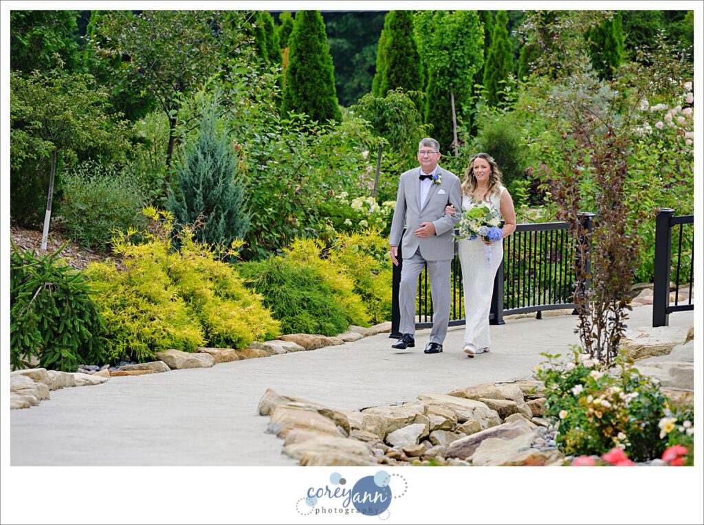 Bride and father walking down aisle to wedding ceremony in North Canton Ohio